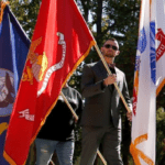 Marine Veteran carring a flag